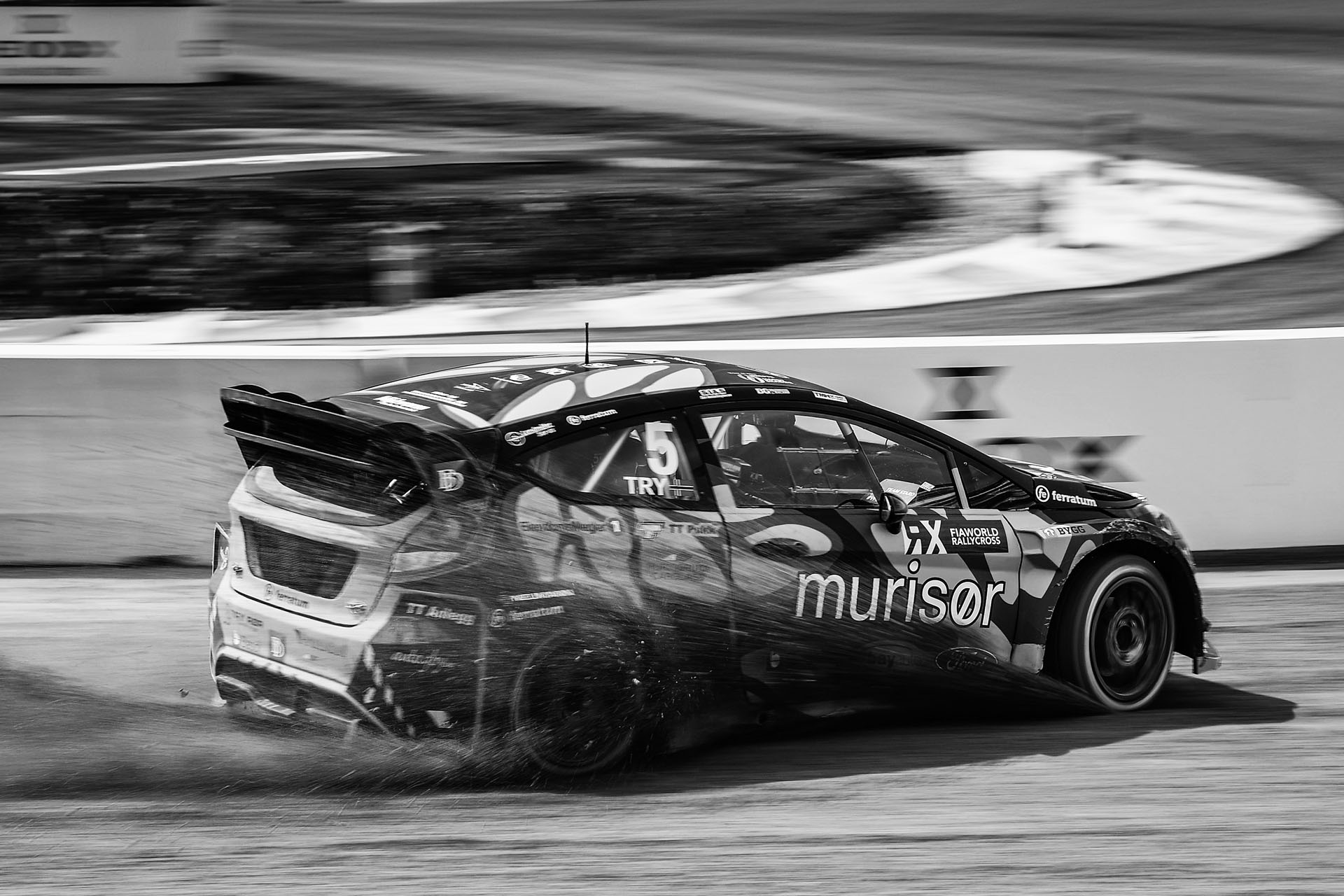 Race car speeding on tarmac